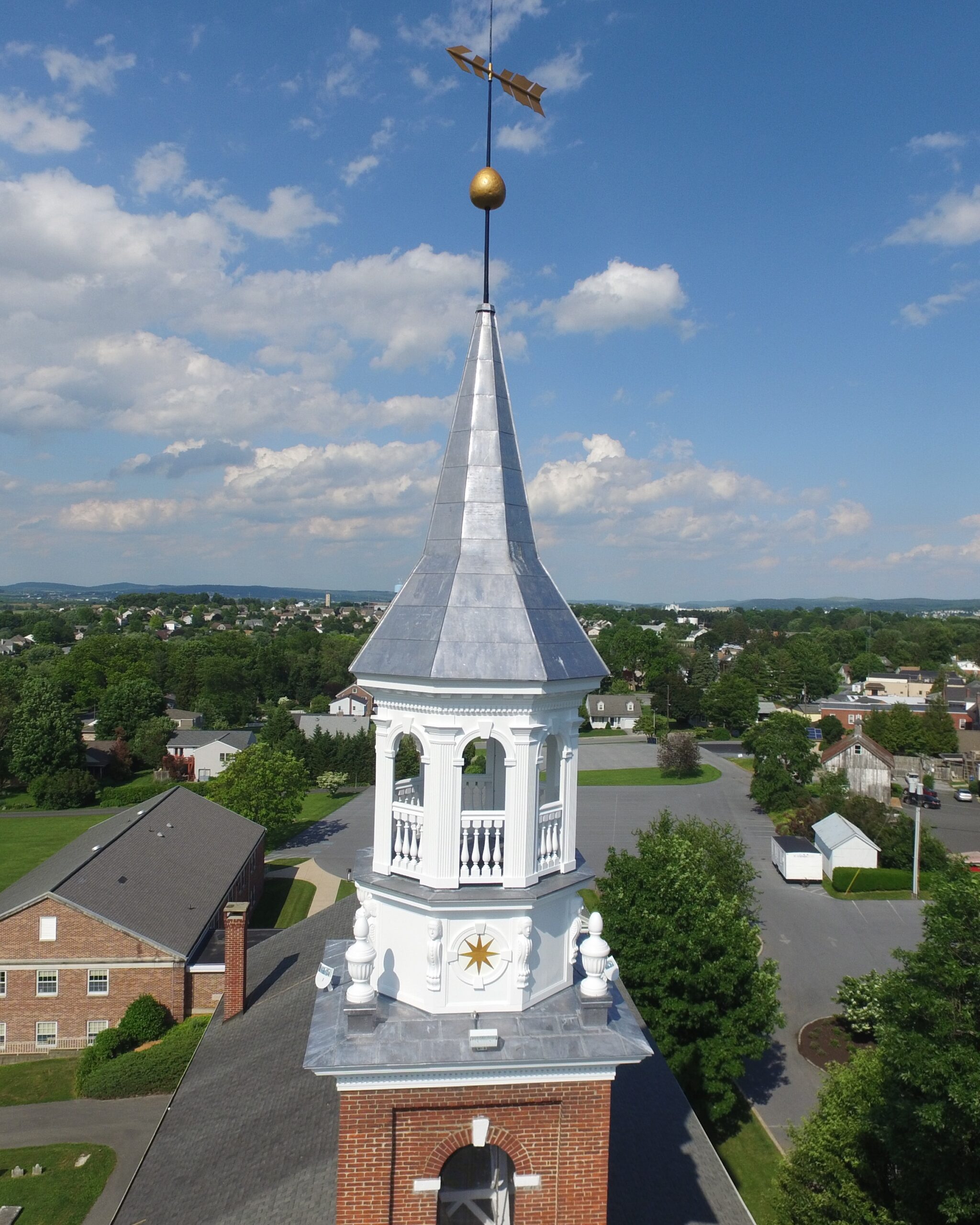 New spire clad in lead-coated copper being lifted onto the 1801 steeple at St. Stephen Reformed Church in New Holland, PA