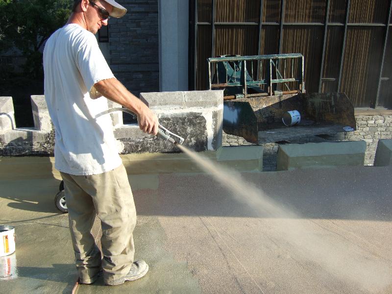 Applying a roof traffic coating with sand
